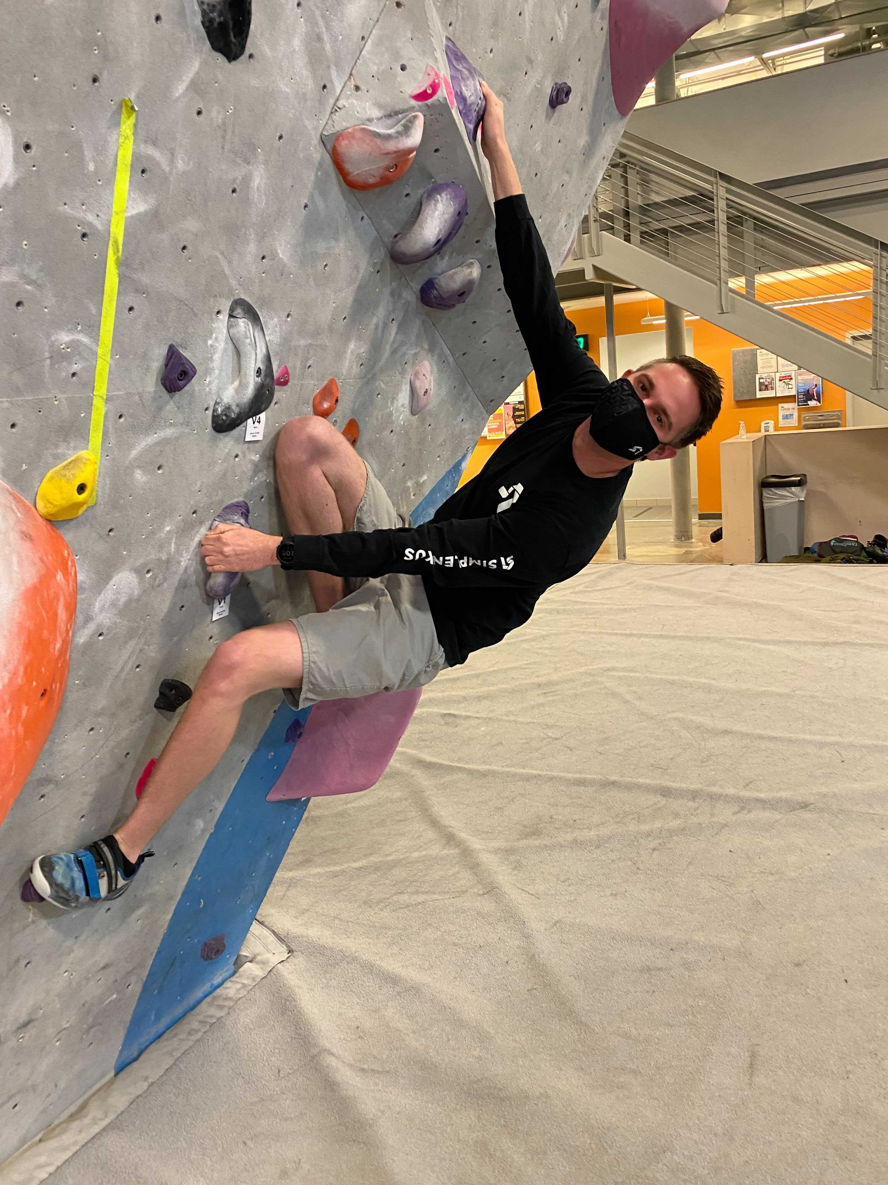 Rock climbing  during COVID with a mask on.